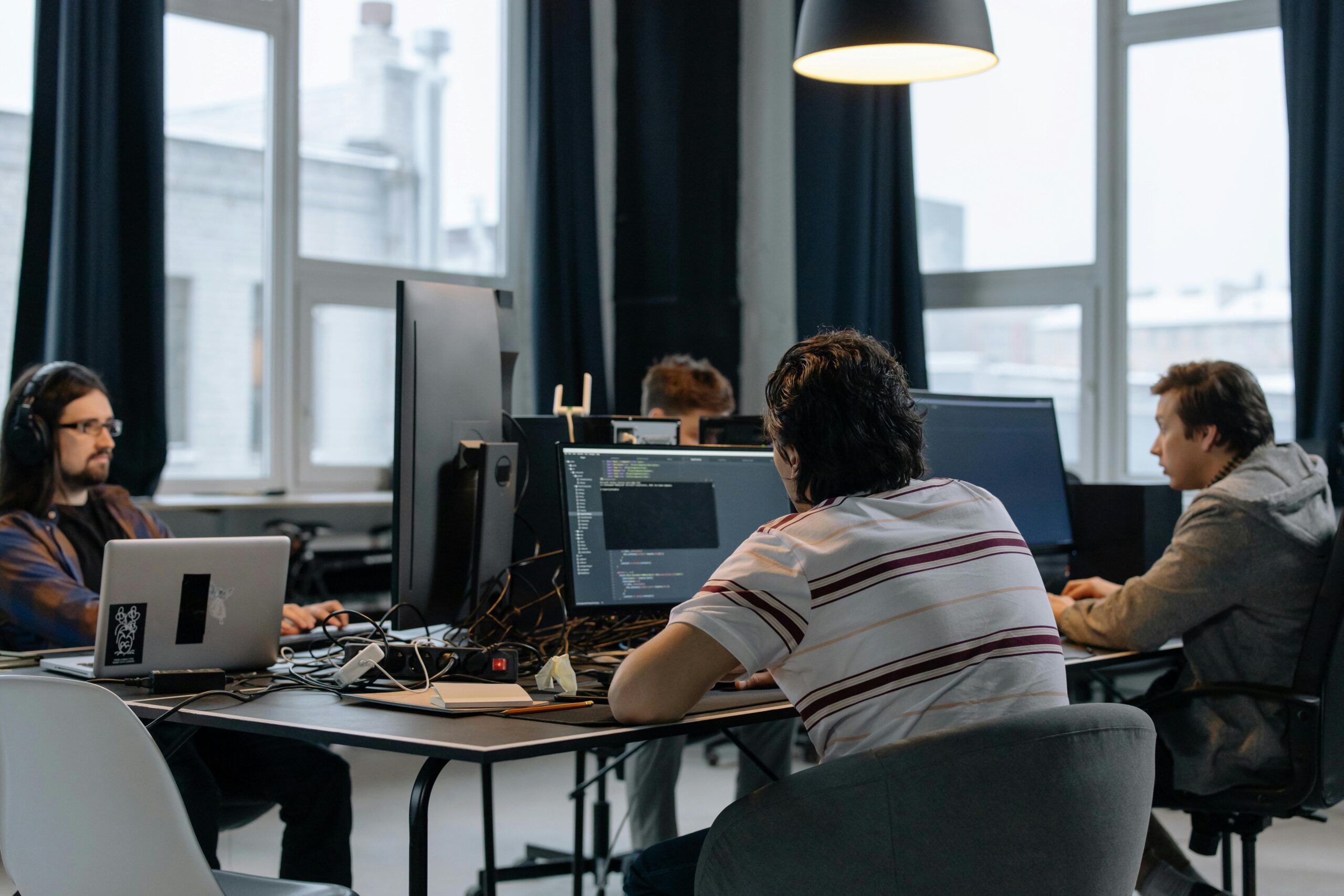 A team of experts collected around a conference table together.
