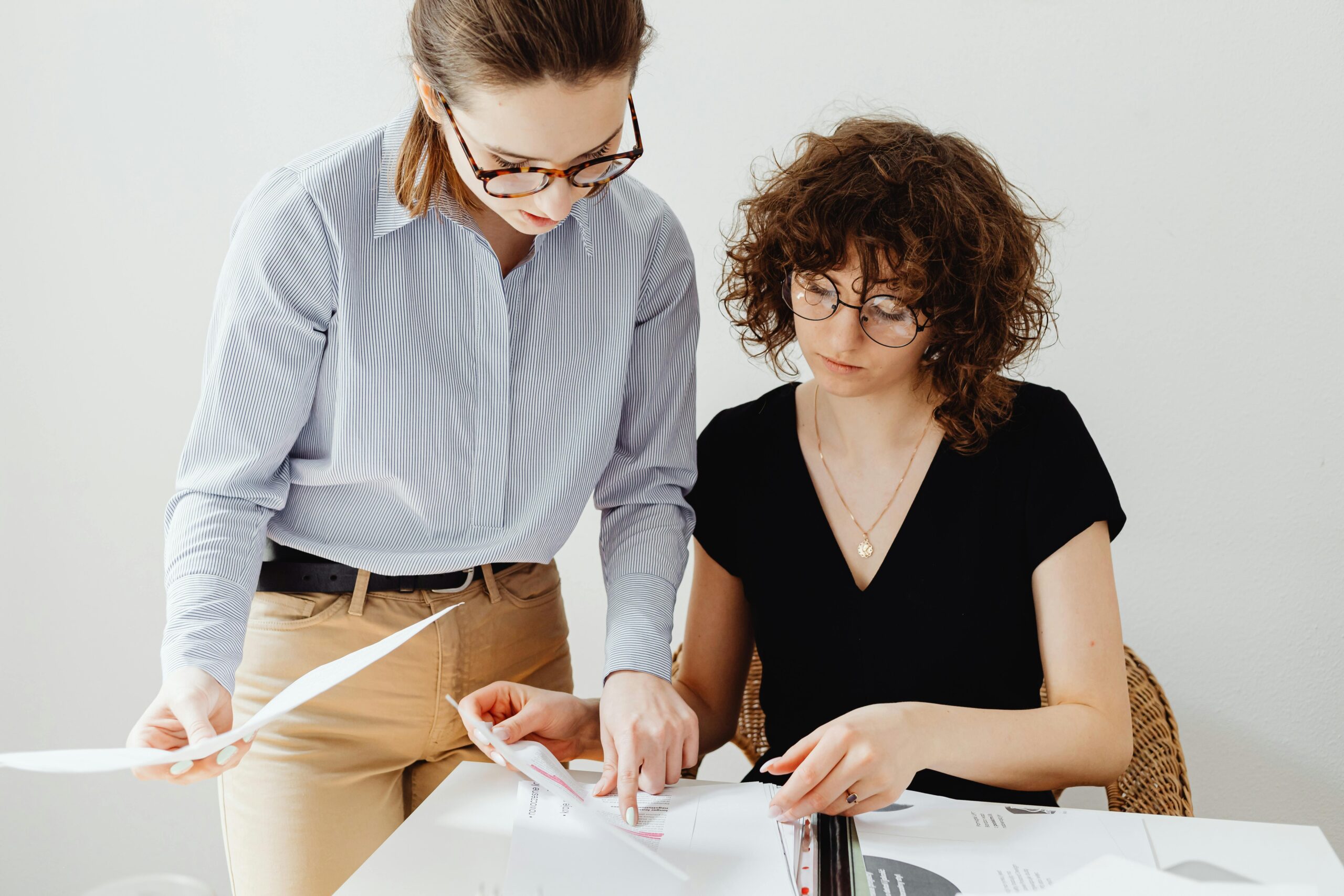Two women going over papers together