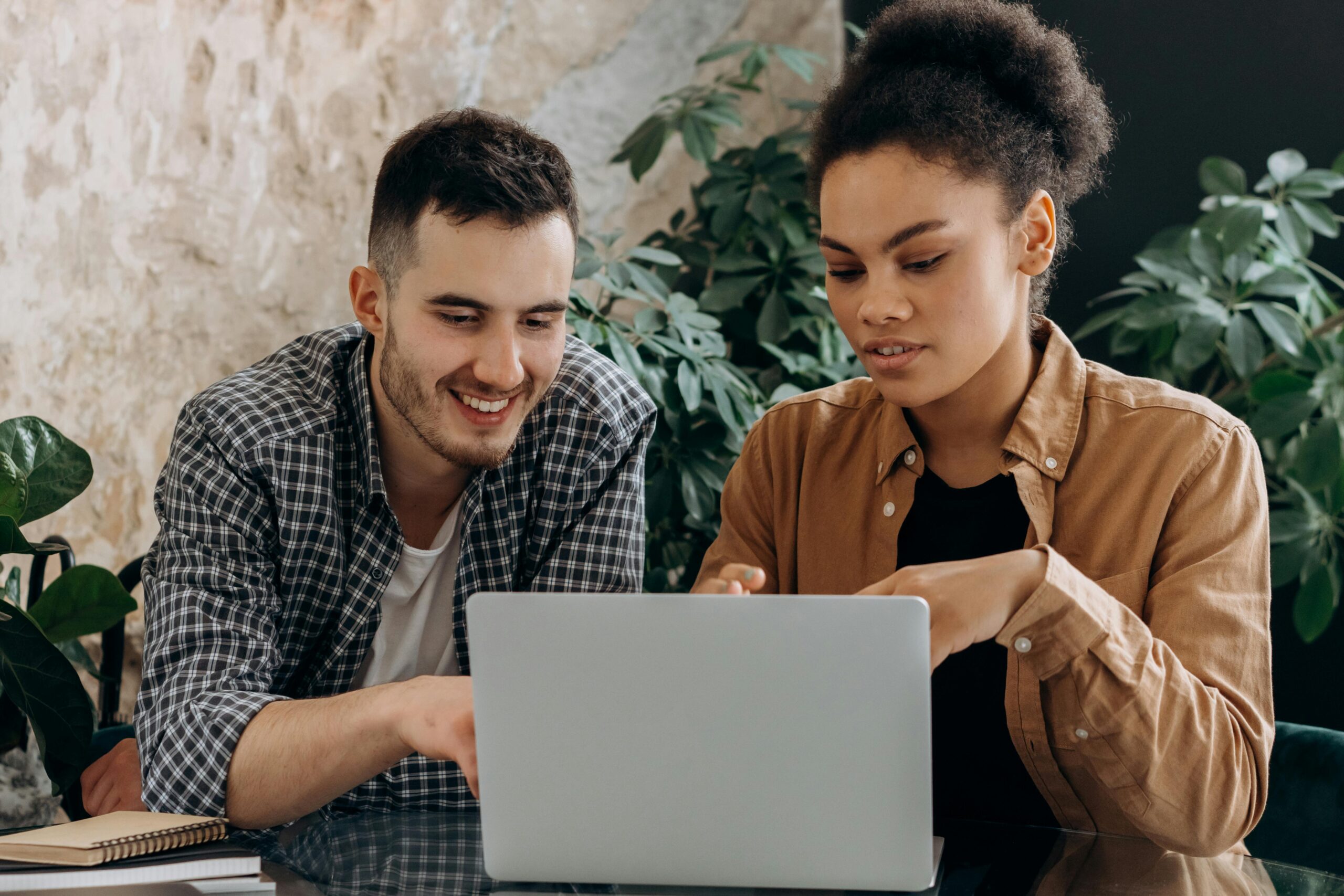 Man and woman working together on a laptop.