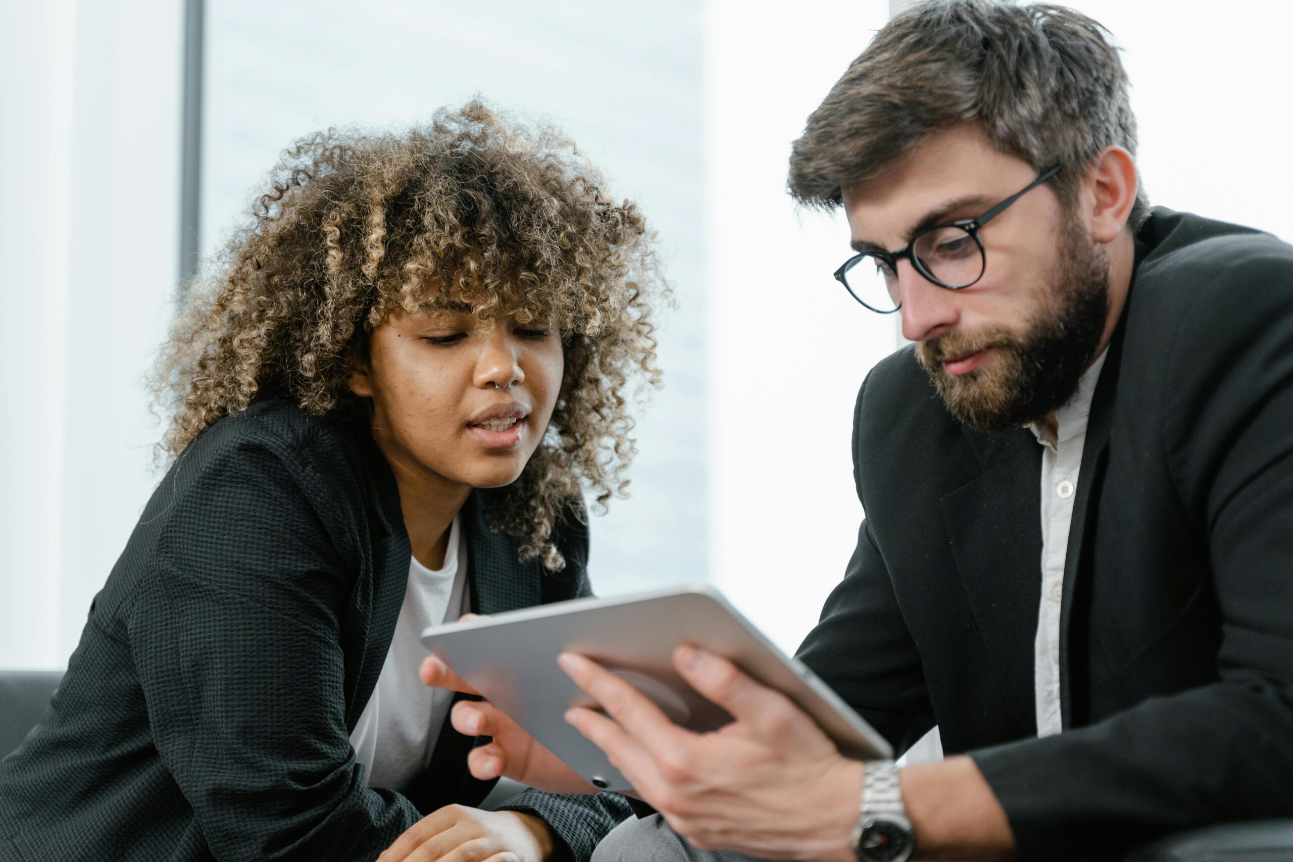 two people reviewing a tablet together
