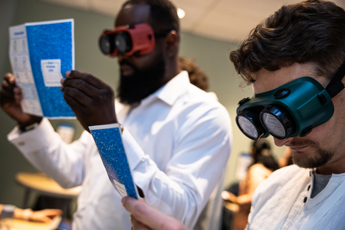 Two Awareness lab participants interacting at an event station