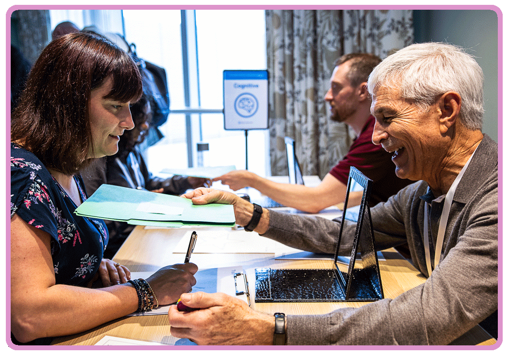 An awareness lab participate smiles while interacting with the Cognitive station